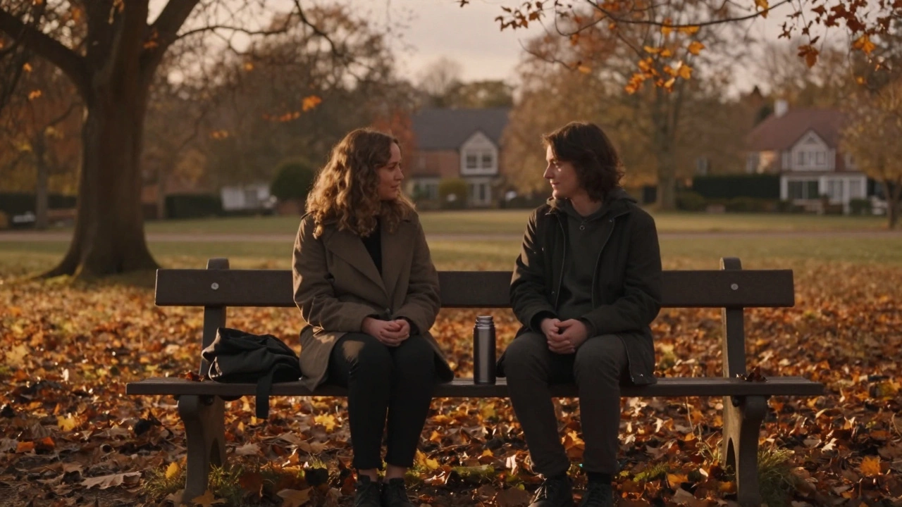 Two people talking peacefully on a park bench in autumn light.