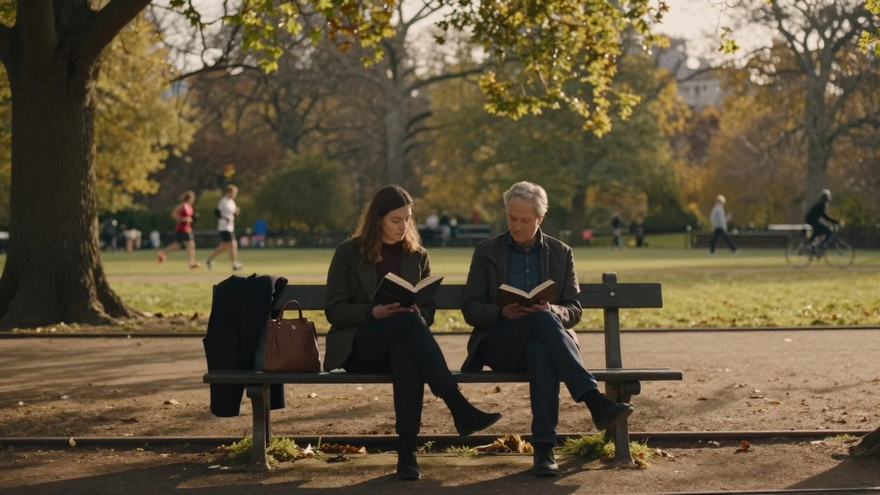 Two people sit together on a bench in Hyde Park, one reading aloud as the other listens attentively at golden hour.